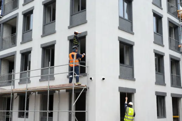 Workers installing compliant cladding system on apartment building façade in Sydney NSW