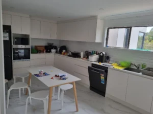 Renovated white kitchen with cabinetry, appliances, tiled splashback and island in Berowra Heights