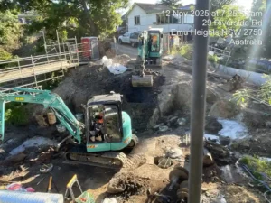 Excavators undertaking bulk excavation and foundation preparation for bridge reconstruction in Emu Heights