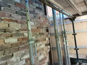 Temporary timber propping supporting a vehicle-impacted wall in Villawood NSW