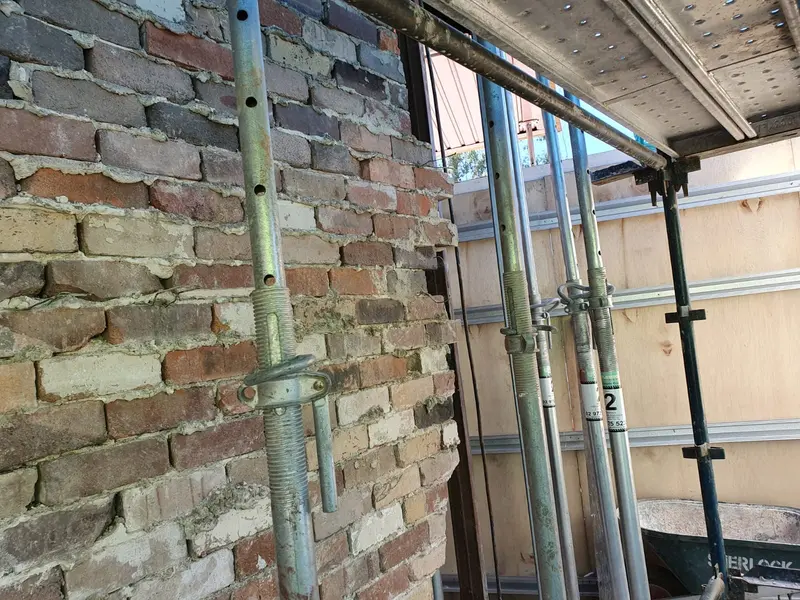 Temporary timber propping supporting a vehicle-impacted wall in Villawood NSW