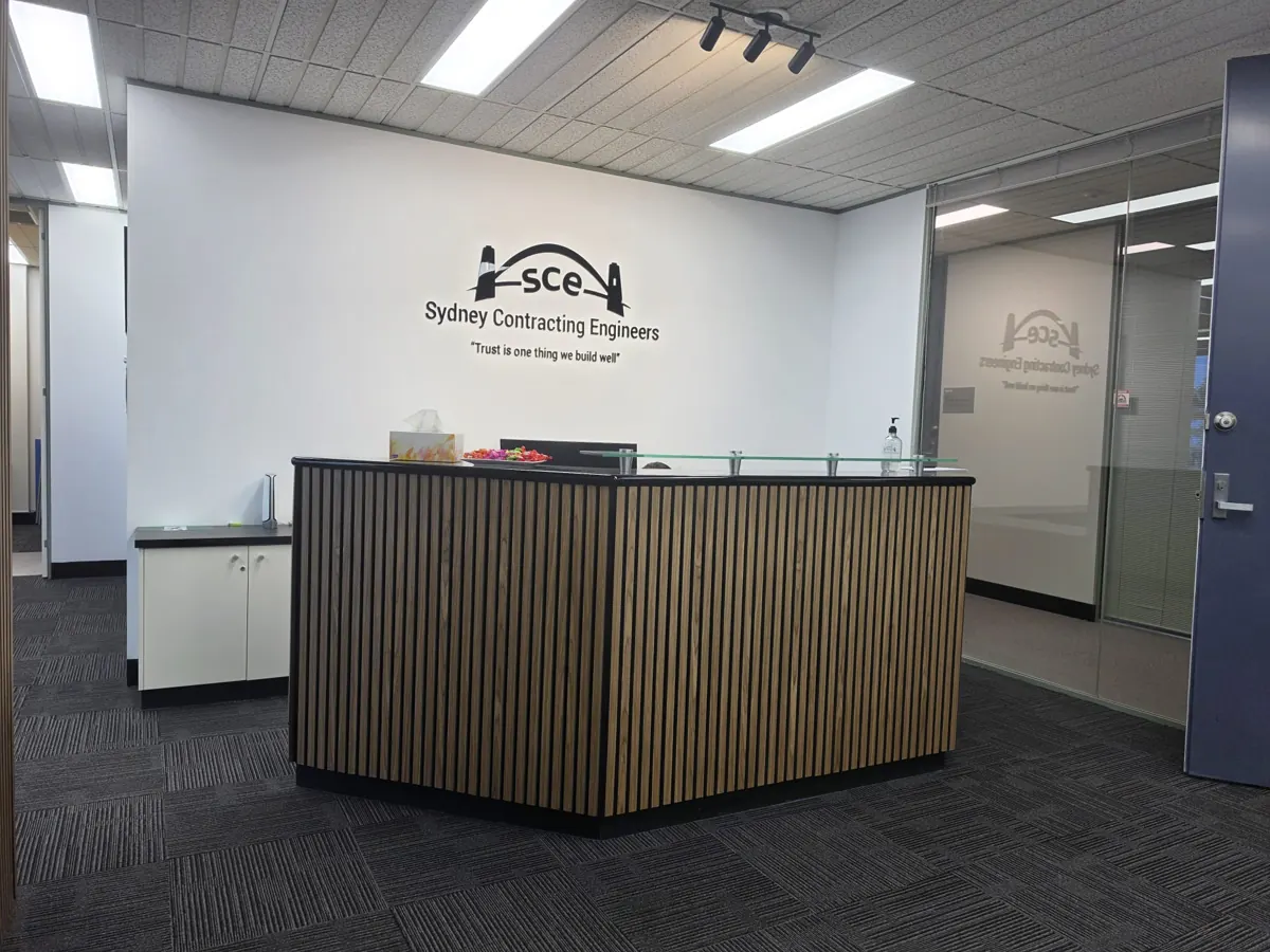 Artarmon office reception after renovation with decorative counter cladding and SCE signage