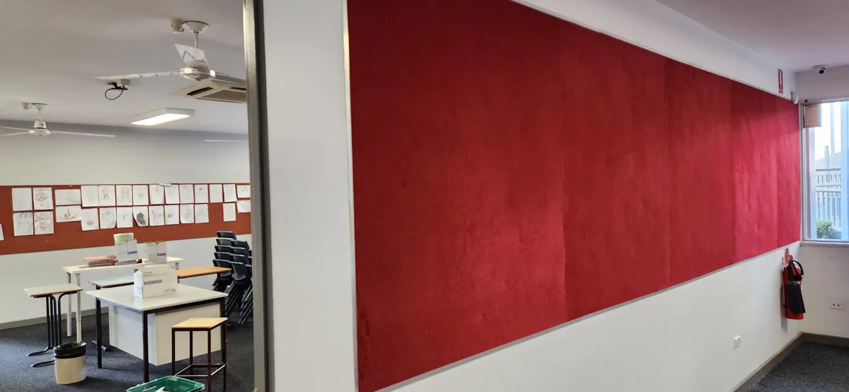 Red acoustic partition beside an open classroom entrance at Cherrybrook Technology High School