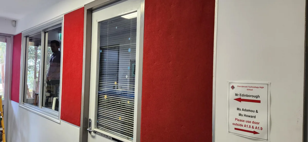 Repainted school circulation area with red acoustic wall treatment at Cherrybrook Technology High School