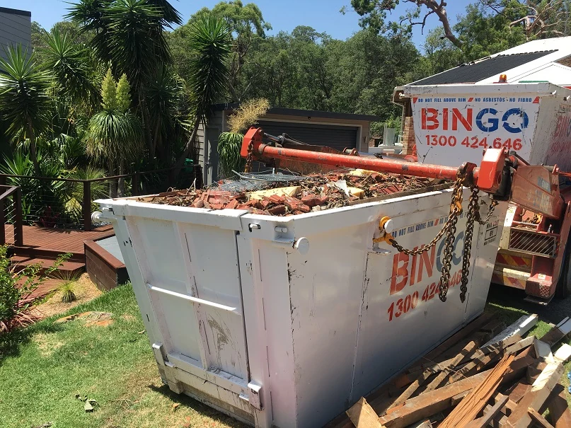 Building debris loaded into a skip during the Grays Point boat shed works