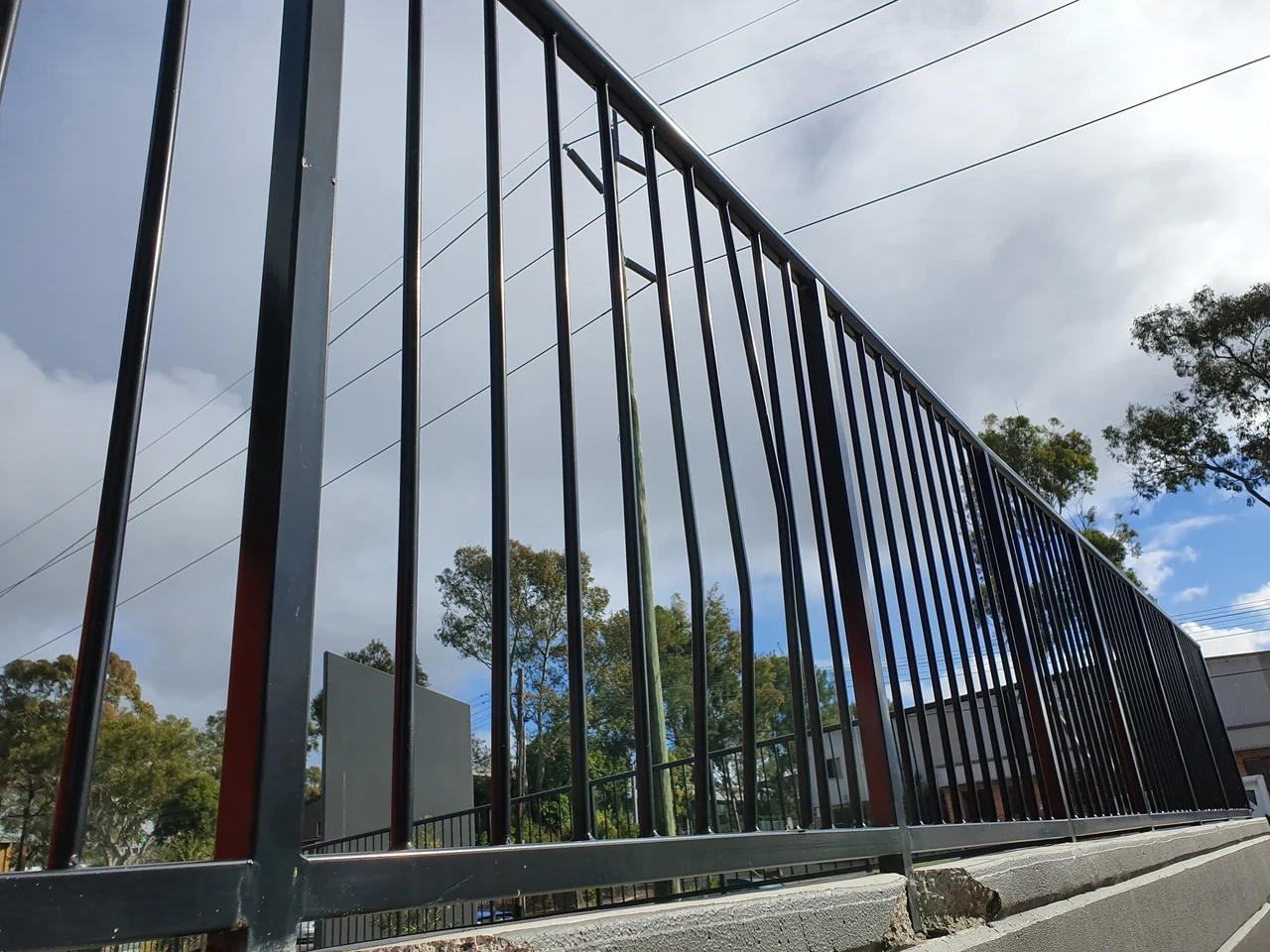 Black balustrade and concrete wall before the Mount Kuring Gai impact repairs