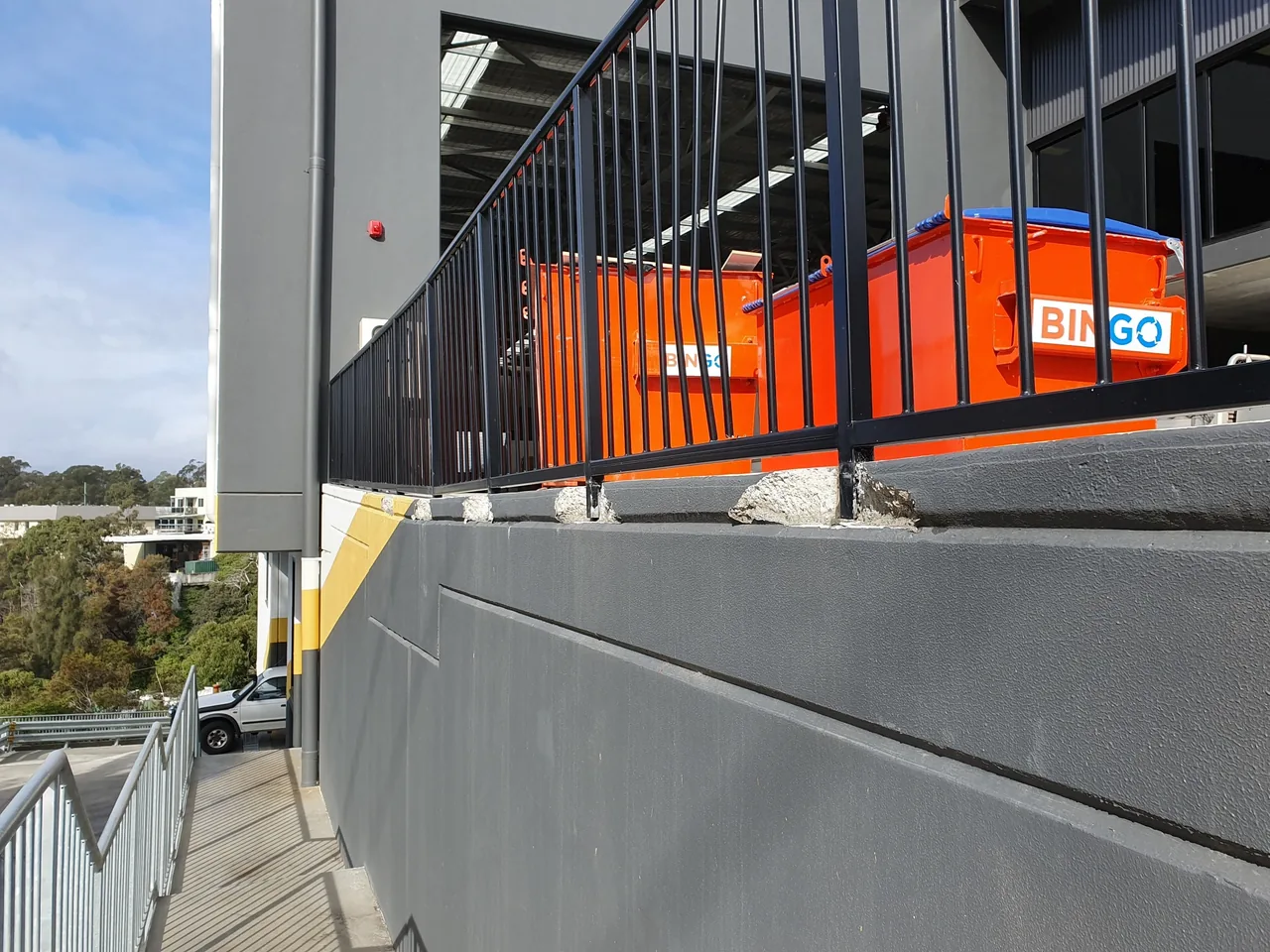 Industrial complex wall and balustrade beside external stairs before repair